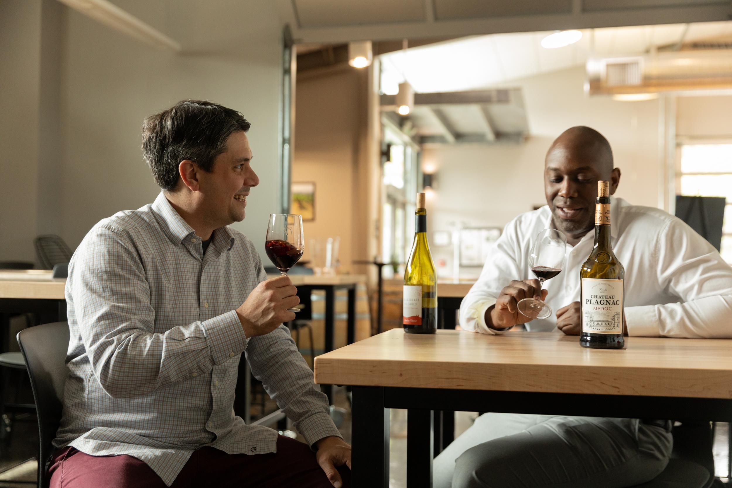 Two people taste wine in the Northwest Wine Academy's tasting room
