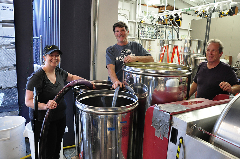 Students and faculty inside the wine making facility